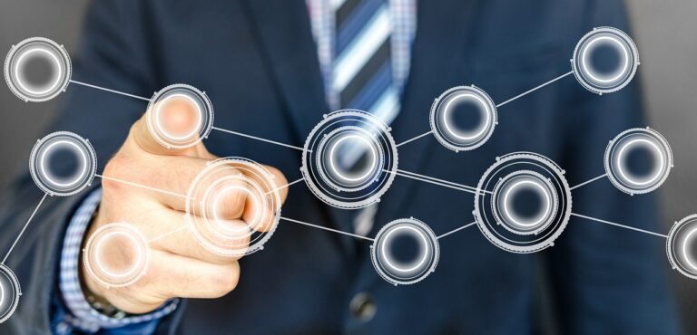 Automation in GRC - a man pressing a button on an automated network.