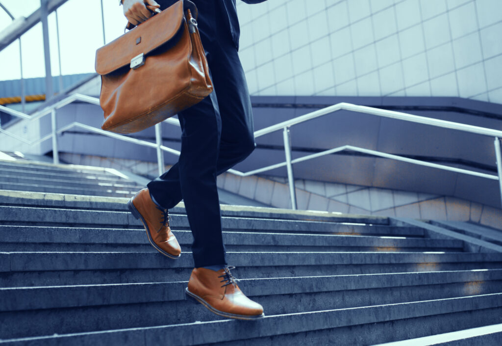 cropped-picture-of-businessman-walking-down-stairs