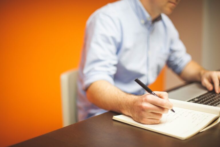 Compliance Catch-Up - a businessman writing a compliance report.