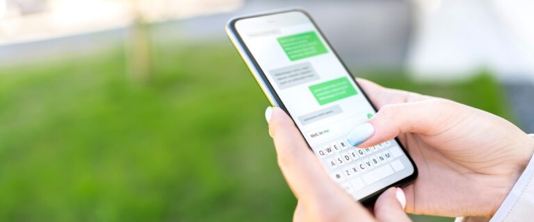 SMS compliance, somebody texting on a mobile phone.