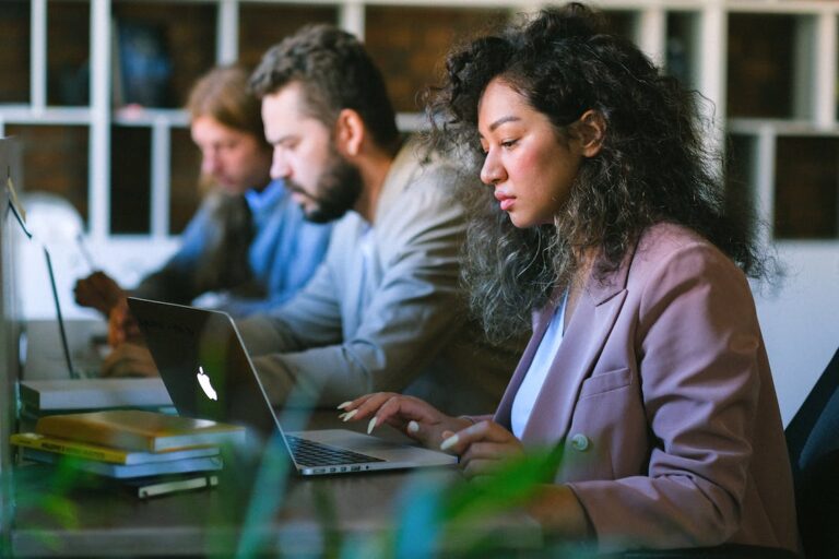 GDPR compliance for software - three developers working on laptops.