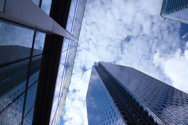 Looking up at buildings of financial companies in the business district of a city.