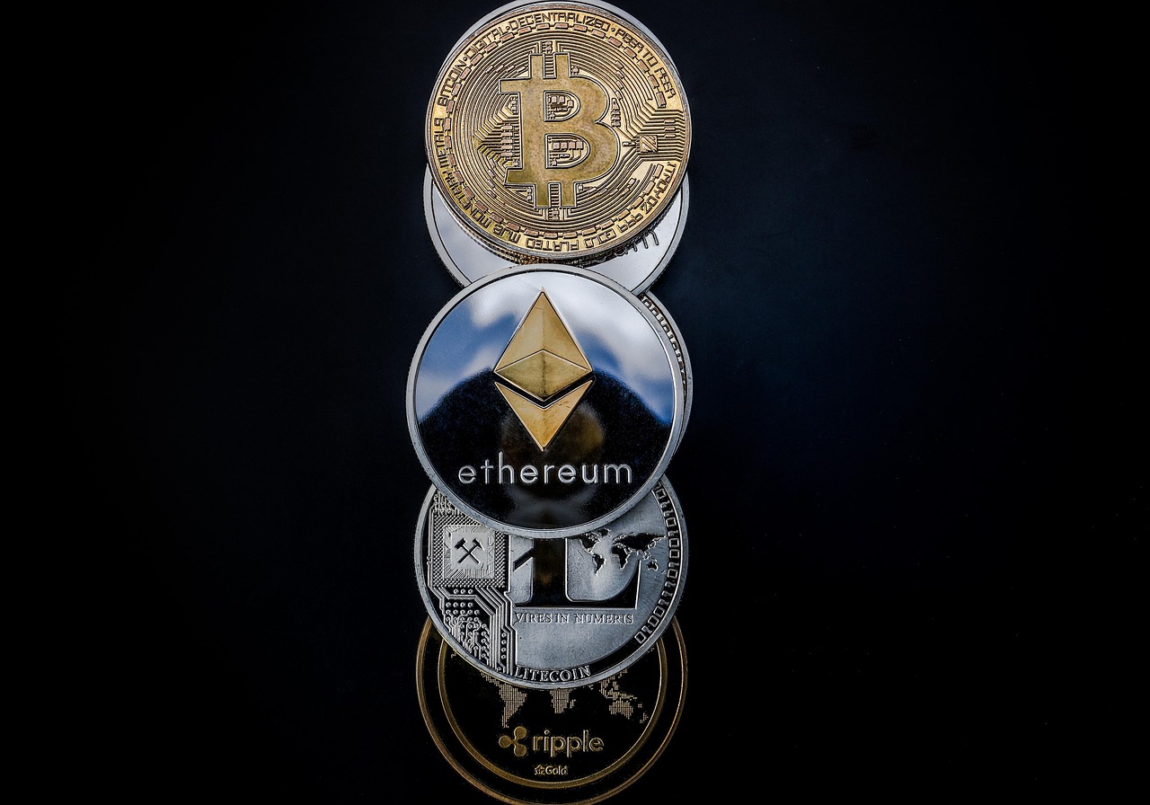 DeFi compliance depicted by Bitcoin, Ethereum, and Ripple cryptocurrency coins.
