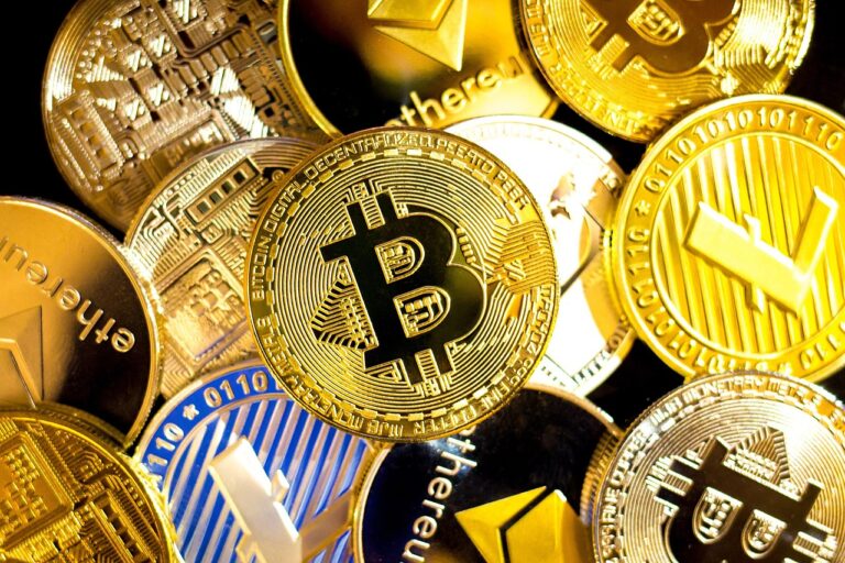 Cryptocurrency coins, including Bitcoin on top of one another.