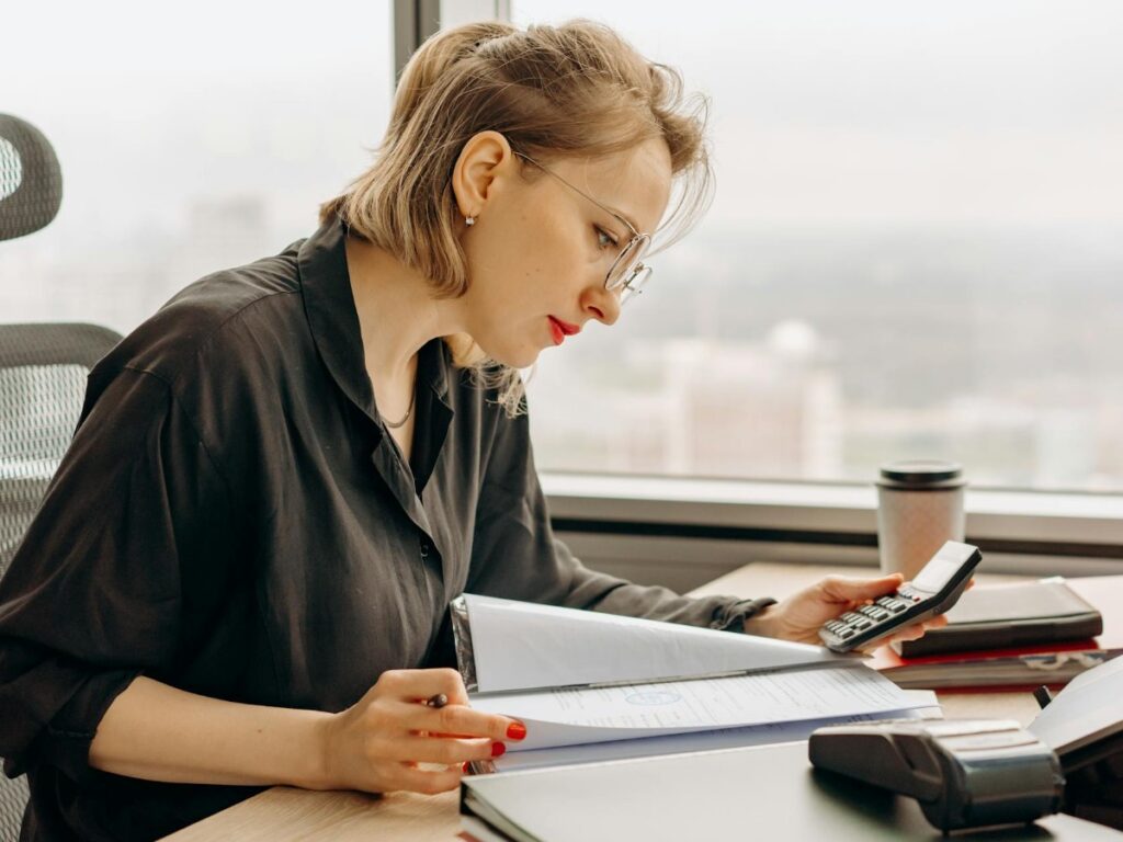 A female accountant checking financial transactions in an office.